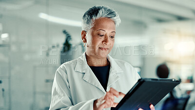 Buy stock photo Woman, scientist and reading on tablet in lab for medical research, gene update and experiment. Mature person, digital and gmo for cells study, review report and virus information for vaccine results