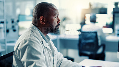 Buy stock photo Innovation, medical and science with black man in laboratory for online development or research. Computer, healthcare and reading with scientist at desk for breakthrough, clinical trial or experiment