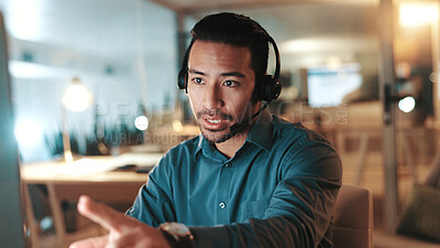 Buy stock photo Computer, explain and headset with man in call center for assistance, help or support at night. Communication, contact us and solution with person at office for online customer service in evening