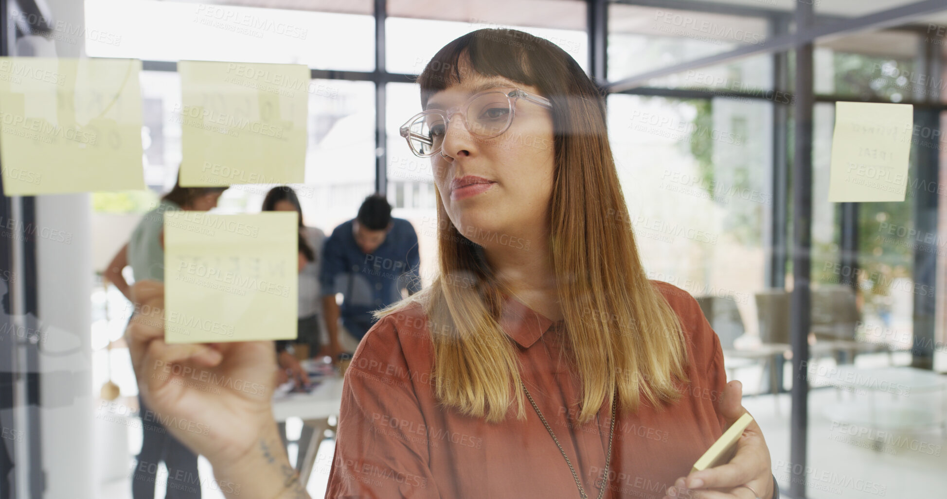 Buy stock photo Office, businesswoman and writing on glass wall for sticky note, strategy and idea for creative agency. Boardroom, female person and writer with planning for information, brainstorming and startup