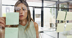 Office, businesswoman and writing on glass wall for strategy, ideas and brainstorming in agency. Sticky note, female person or creative writer with moodboard for information, planning or startup goal