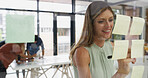 Office, businesswoman and happy on glass wall for writing, strategy and brainstorming in agency. Sticky note, female person or creative writer with moodboard for information, planning or startup goal