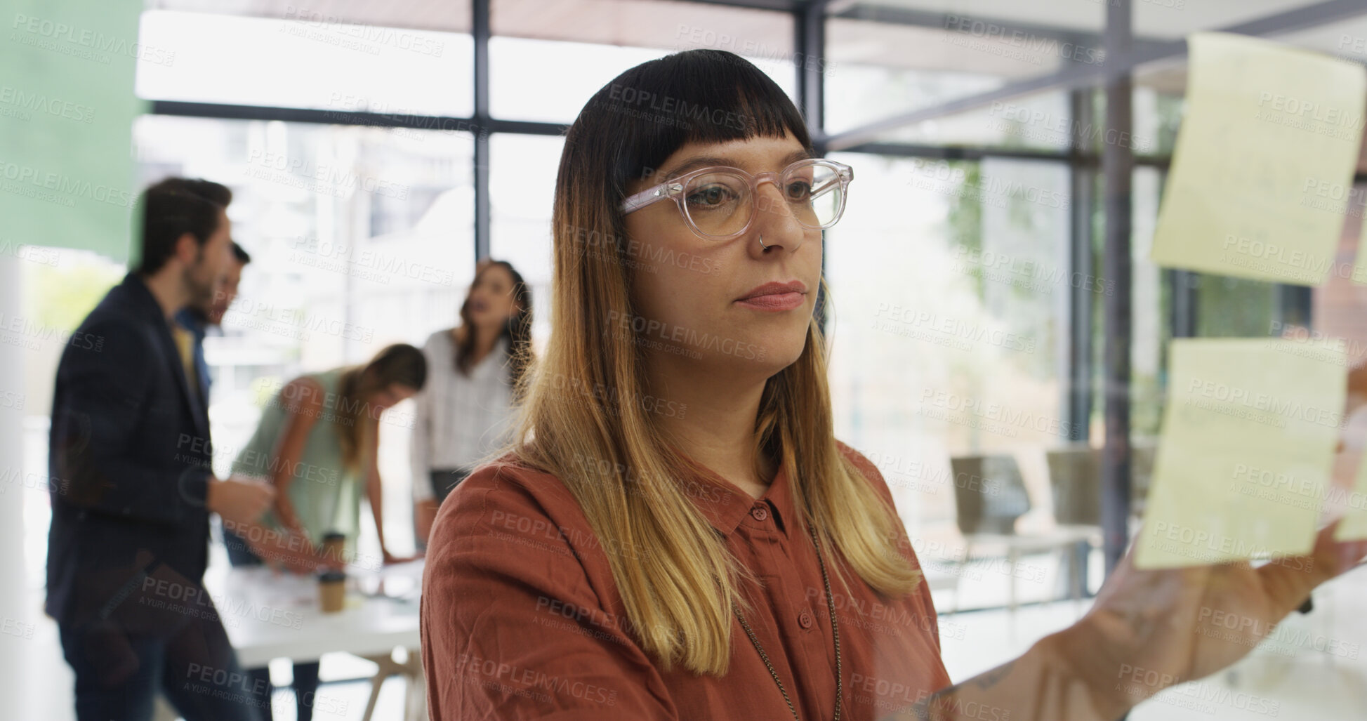 Buy stock photo Woman, sticky note and planning by window at office, idea or review for project management at startup. Person, paper and mindmap with glass, task or perspective with moodboard at creative agency