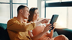 Happy, couple and pointing on tablet at house for social media, browsing internet and bonding. Smile, people and digital for streaming online, search movie and app subscription for film entertainment