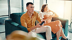 Concentration, frustrated and gaming with couple on sofa in living room of home for relationship. Annoyed, distraction or ignore with gamer man and woman in apartment for challenge or competition