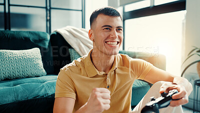 Buy stock photo Playing, games and man with controller in home, living room and excited with tech for entertainment. Happy, gamer and person with console for virtual sport, chilling and win of digital tournament