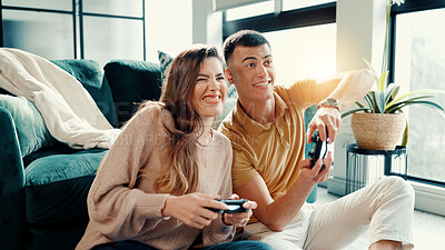Buy stock photo Competition, gamer couple and having fun in living room of home together for bonding or dating. Challenge, remote controller and video game with people in apartment for entertainment or relationship
