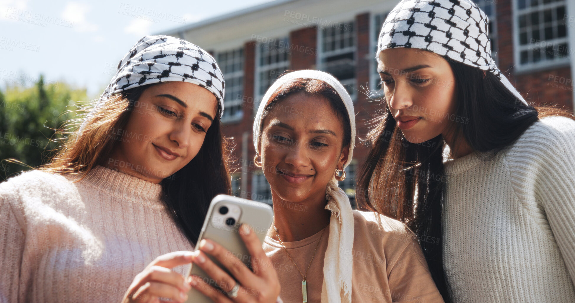 Buy stock photo Phone, keffiyeh and support with friends in city for protest post, human rights and social justice. Palestine relief, community and online update with women outdoor for genocide awareness and peace