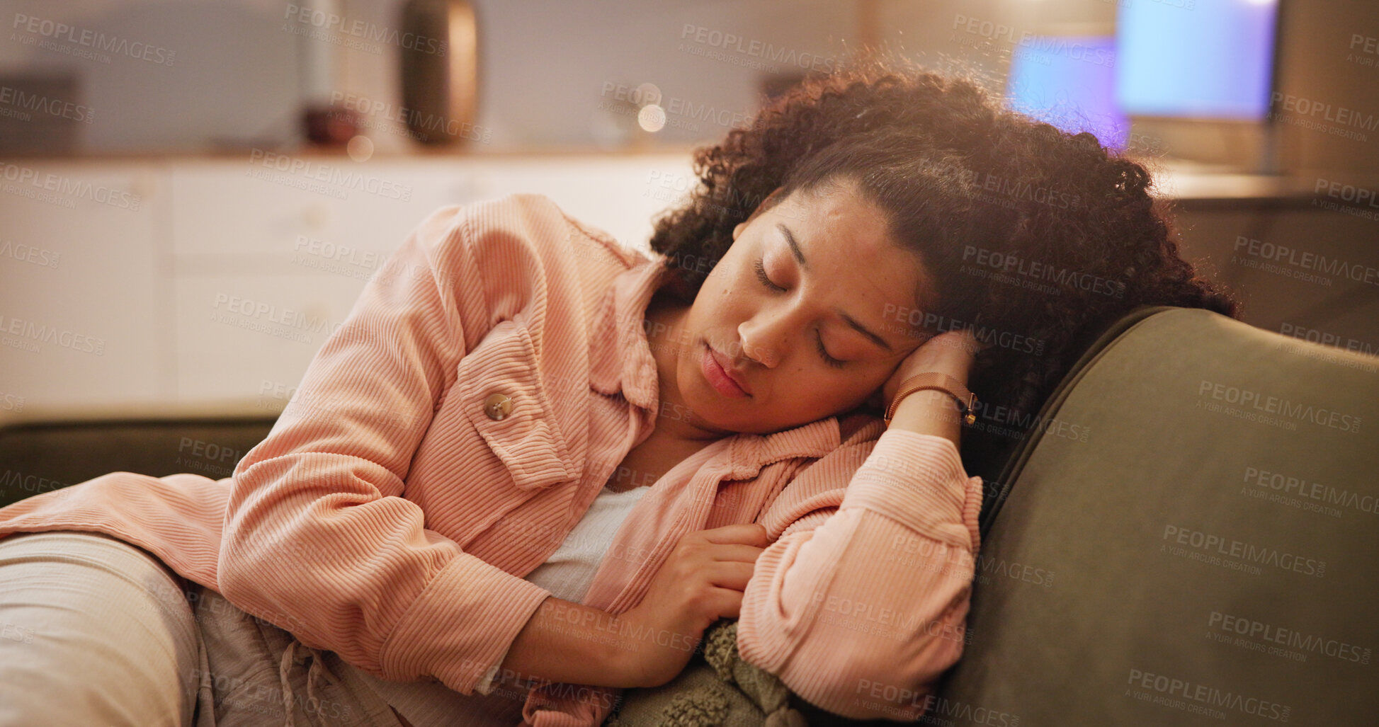 Buy stock photo Tired woman, sleeping and night on sofa for rest, nap or snooze in living room at home. Female person, fatigue or lying asleep with comfort on couch for dream, break or cozy late evening at house