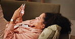 Woman, relax and smile on couch for phone, online chat and match on dating website with contact. Home, female person and happiness with mobile for app, friend request and notification on social media