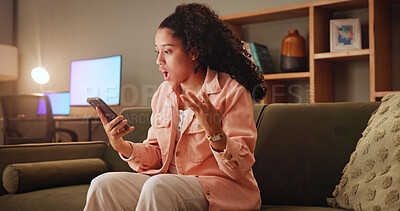Buy stock photo Woman, shock and phone with texting on sofa, wow and notification for fake news on social media. Girl, smartphone and surprise at night on mobile app, chat and gossip with contact on couch at house