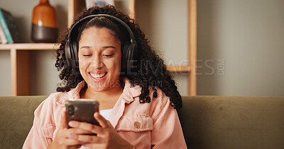 Buy stock photo Girl, phone and happy on sofa with headphones, texting and contact for funny chat in living room. Woman, smartphone and laugh with listening to music, streaming and social media on couch at apartment
