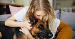 Home, woman and kiss for dog, hug and affection for german shepherd in living room or rescue animal. Care, adoption and person with pet in lounge, bonding or love for canine with loyalty in apartment