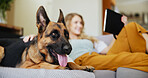 Woman, dog and relax with tablet on sofa for pet insurance, care or love for companion at home. Female person, animal and break with canine or german shepherd on couch for comfort or cozy shelter