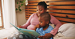 Home, reading book and mother with boy, bedroom and bonding together with knowledge. African family, mama and son with storytelling, learning and child development with hobby, literacy and help