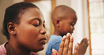 Praying, worship and black mother with kid in home for religion, praise or spiritual wellness. Bonding, hope and African mom teaching boy child with christian prayer in morning for gratitude in house