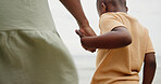 Holding hands, parent and child at beach on holiday with care, love and bonding in nature. People, kid and support with connection, outdoor and vacation for family with back, ocean and getaway by sea