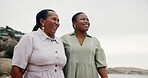 Black women, mother and daughter with smile on beach for travel, summer holiday and ocean getaway. Happy, mature mom and family for tropical vacation, walking support and sightseeing for nature trip