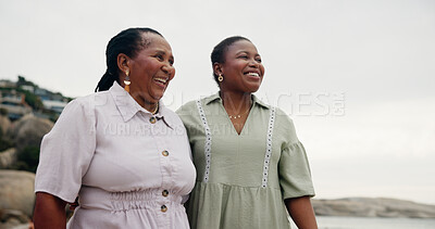 Buy stock photo Black women, mother and daughter with smile on beach for travel, sea holiday and ocean getaway. Happy, mature mom and family for vacation space, walking support and sightseeing for nature trip