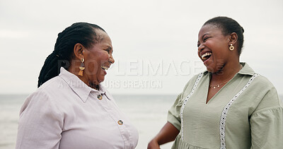 Buy stock photo Mature mother, daughter and beach outdoor for travel, sea holiday and ocean getaway. African women, family and laughing for retirement vacation, funny joke and bonding together for nature trip