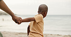 Black family, child or holding hands on beach for safety, security or outdoor bonding together. Son, kid or support with parent or guardian on ocean coast, sandy shore or sea for childhood protection