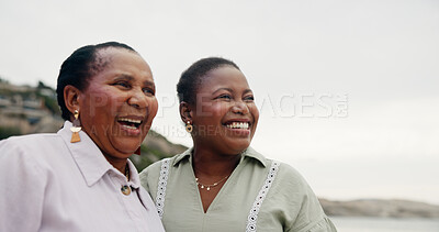 Buy stock photo Smile, mature mother and daughter on beach for travel, holiday view and getaway. Women, African family and laughing with love for ocean trip, vacation journey and bonding together for weekend break