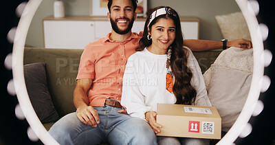 Buy stock photo Couple, ring light and box with live stream in home, smile and portrait with post on web in lounge. Influencer, man and woman with unboxing video, recording and happy with social media at apartment