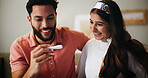 Couple, pregnancy test and excited with results on sofa with hug, happy and fertility in home. People, man and woman with stick, smile and surprise for baby, success and love with support at house