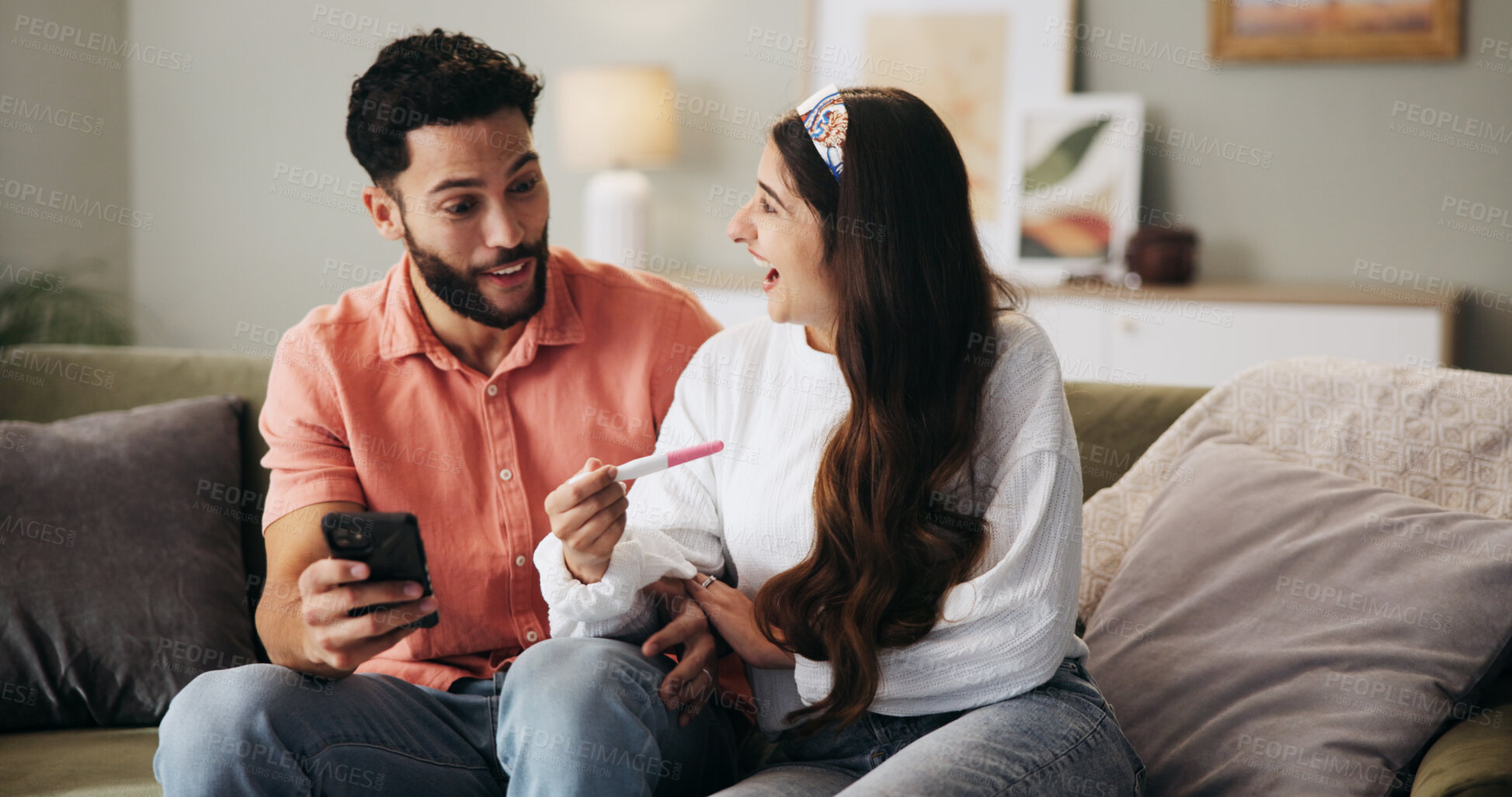 Buy stock photo Couple, phone and excited on sofa with pregnancy test, results or happy for fertility in home. People, man and woman with stick, smile and surprise for baby, IVF success or tech with support at house