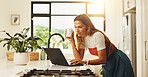 Online, laptop and woman in kitchen, home and planning for blog on social media, typing or creative. Apartment, writer and person with tech for post on website, blogger and remote work in house