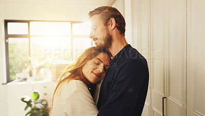 Buy stock photo Happy, love and couple hugging in kitchen for safety, care and marriage commitment together in home. Smile, connection and woman embracing man for relationship bonding on weekend morning in apartment
