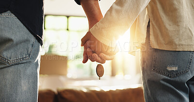 Buy stock photo Couple, holding hands and new home with keys for moving in, fresh start or beginning together. Back view, man and woman with support or access to apartment, building or asset for property or house