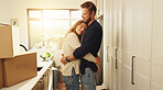 Smile, couple and hug with boxes at new house of relocation, investment and bonding together. People, embrace and affection, moving property and relationship commitment with security of home purchase