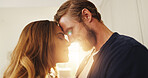Home, forehead and couple with love, lens flare or bonding together with happiness, romance or trust. Apartment, support or man with woman, relationship or marriage with kindness, commitment or smile
