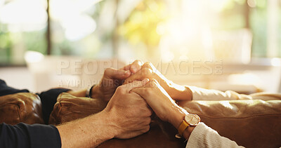 Buy stock photo Holding hands, sofa and couple in home for love, affection and connection for relationship. Marriage, communication and man with woman together for bonding, support and commitment in living room