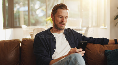 Buy stock photo Reading, sofa and man with phone in home for social media, online networking and chat on mobile app. Relax, news and person on smartphone for internet, contact and message notification on weekend