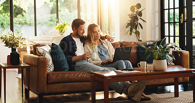 Buy stock photo Couple, planning or laptop in home to relax for online blog, interior design research or post. Pointing, lounge decoration or people on sofa with coffee or technology for house renovation or tips