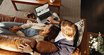 Laptop, relax and top view of couple in home to search for deal on accommodation or hotel booking. Above, holiday or people on couch together for bonding, travel options or resort homepage for review