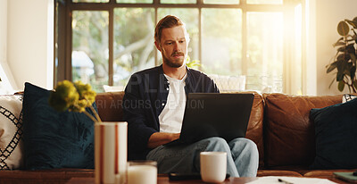 Buy stock photo Man, relax and reading on sofa with laptop, social media and ebook for information in home. Person, network or tech in living room for streaming subscription, email notification and download new app