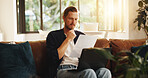 Man, document and reading on sofa with laptop, writer and thinking for script draft in home. Person, editor and technology in living room for paperwork, networking and application with freelancer