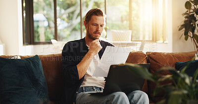 Buy stock photo Man, document and reading on sofa with laptop, writer and thinking for script draft in home. Person, editor and technology in living room for paperwork, networking and application with freelancer