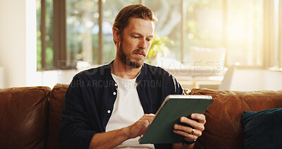 Buy stock photo Man, relax and reading on sofa with tablet, social media and ebook for information in home. Person, network or tech in living room for streaming subscription, email notification and download new app