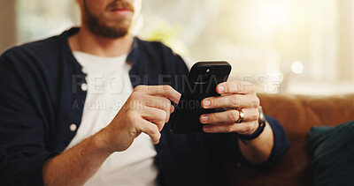 Buy stock photo Typing, sofa and man with phone in home for social media, online networking and chat on mobile app. Apartment, hands and person on smartphone for internet, contact and message notification on weekend