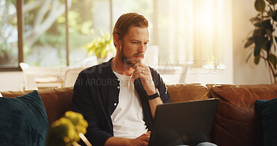 Buy stock photo Man, website and reading on sofa with laptop, writer and thinking for script draft in home. Person, editor and technology in living room for research, networking and application with freelancer