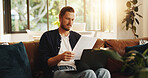 Man, paperwork and reading on sofa with laptop, writer and thinking for script draft in home. Person, editor and technology in living room for research, networking and application with freelancer