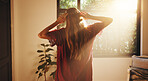 Back, woman and stretching by window for sunshine, freedom and ready to start day in house. Home, good morning and person with view in bedroom for wake up, flare and fresh with energy on weekend