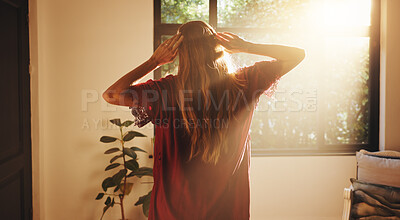 Buy stock photo Back, woman and stretching by window for sunshine, freedom and ready to start day in house. Home, good morning and person with view in bedroom for wake up, flare and fresh with energy on weekend