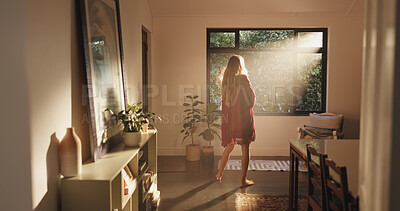 Buy stock photo Back, sunshine and woman by window for thinking, vision or ready to start day in home. House, good morning and person with view, flare and reflection while daydreaming on weekend with peace or calm