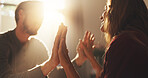 Home, hands together and couple in lounge, love and bonding with support. Romance, lens flare and man with woman, kindness and relationship with affection, happiness or marriage in living room