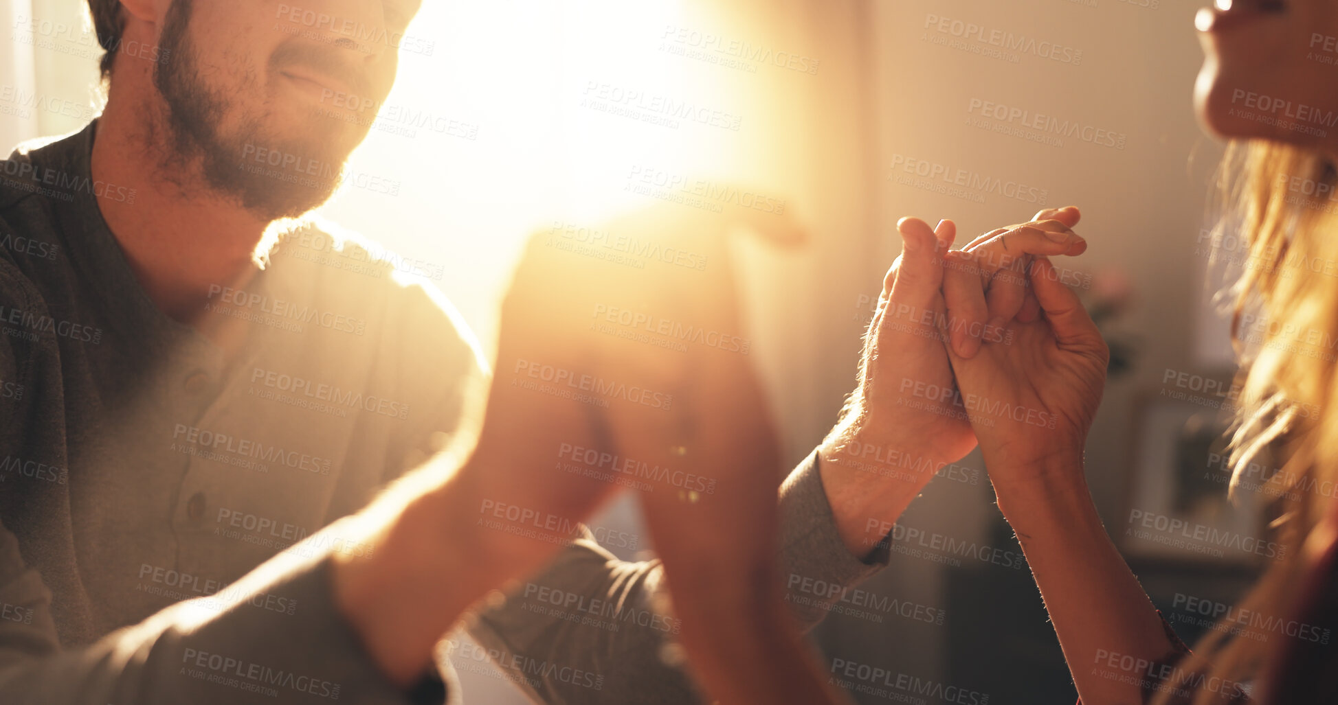 Buy stock photo Home, hands together and couple with love, support and bonding with relationship. Romance, lens flare and man with woman, kindness and care with affection, happiness or marriage with commitment
